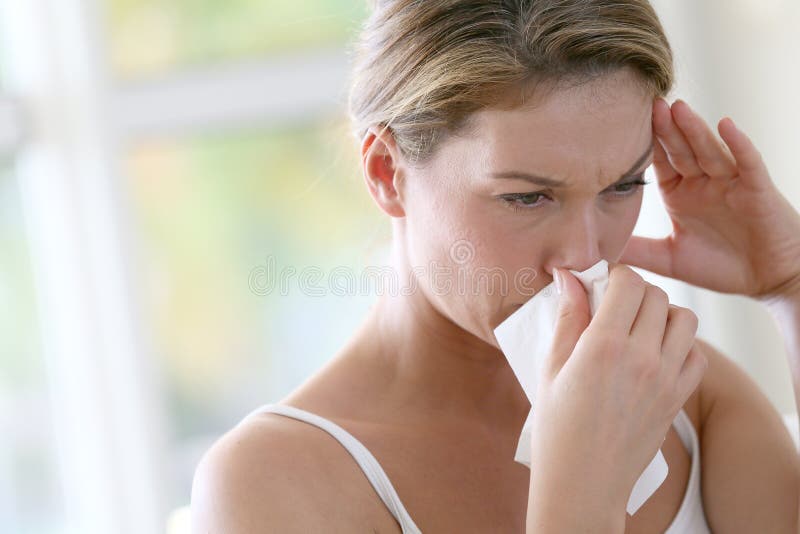 Portrait of womanwith allergy blowing her nose. Portrait of womanwith allergy blowing her nose