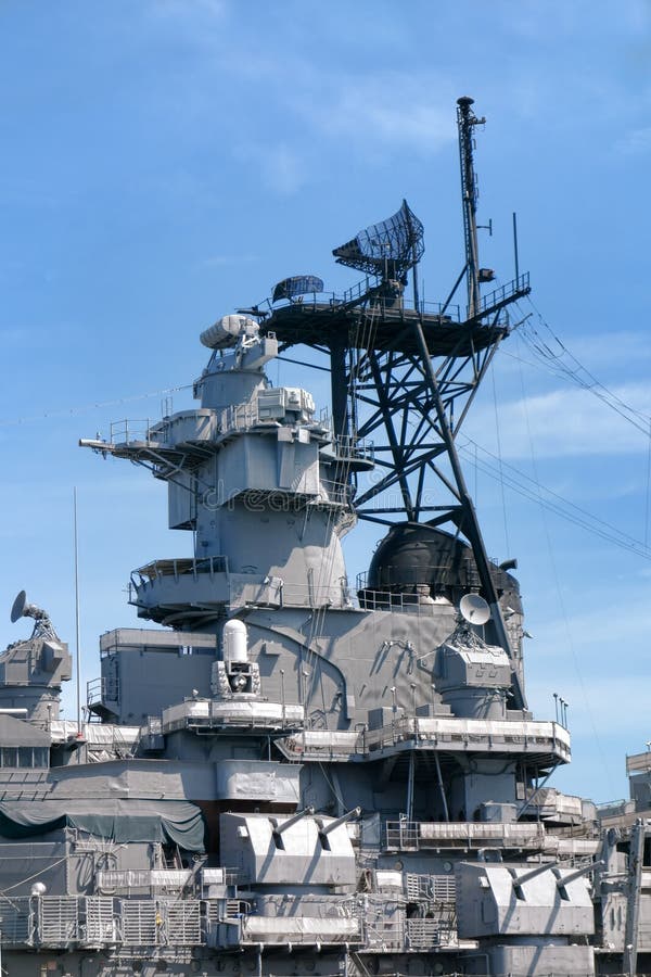 Command tower with radar and communication equipment above antiaircraft guns weapons on a US navy battleship. Command tower with radar and communication equipment above antiaircraft guns weapons on a US navy battleship