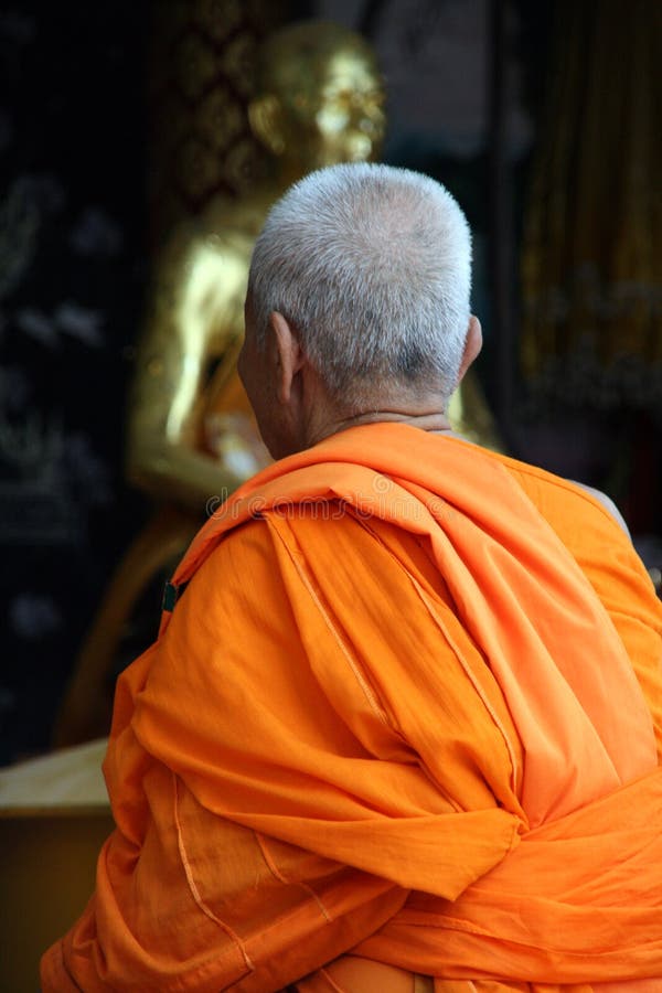 Buddhist monk in orange robe at big buddha temple samui island thailand. Buddhist monk in orange robe at big buddha temple samui island thailand