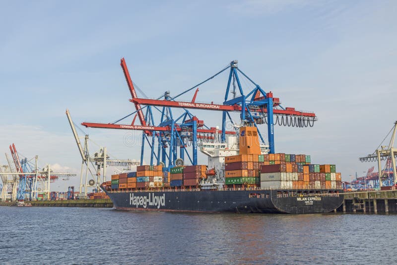 HAMBURG, GERMANY - AUG 2, 2017: ship of Hapag Lloyd is loaded with huge cranes in harbor of Hamburg. HAMBURG, GERMANY - AUG 2, 2017: ship of Hapag Lloyd is loaded with huge cranes in harbor of Hamburg