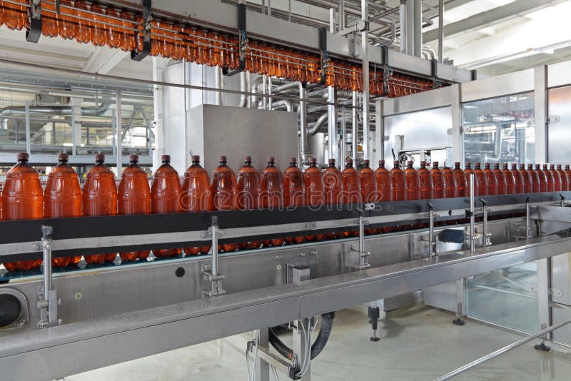 The food industry. Plastic beer bottles moving on conveyor. The food industry. Plastic beer bottles moving on conveyor