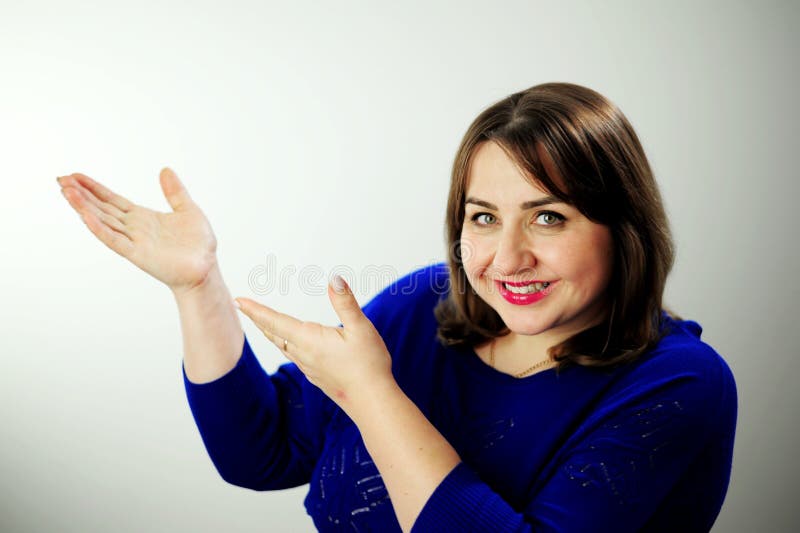 woman showing hand for product advertising Hey look. Smiling pretty female model pointing fingers left at empty space and inviting to check it out, showing advertisement on white background. woman showing hand for product advertising Hey look. Smiling pretty female model pointing fingers left at empty space and inviting to check it out, showing advertisement on white background