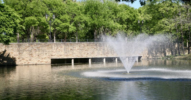 A beautiful water fountain and stone cobblestone bridge set in a residential area. A beautiful water fountain and stone cobblestone bridge set in a residential area.