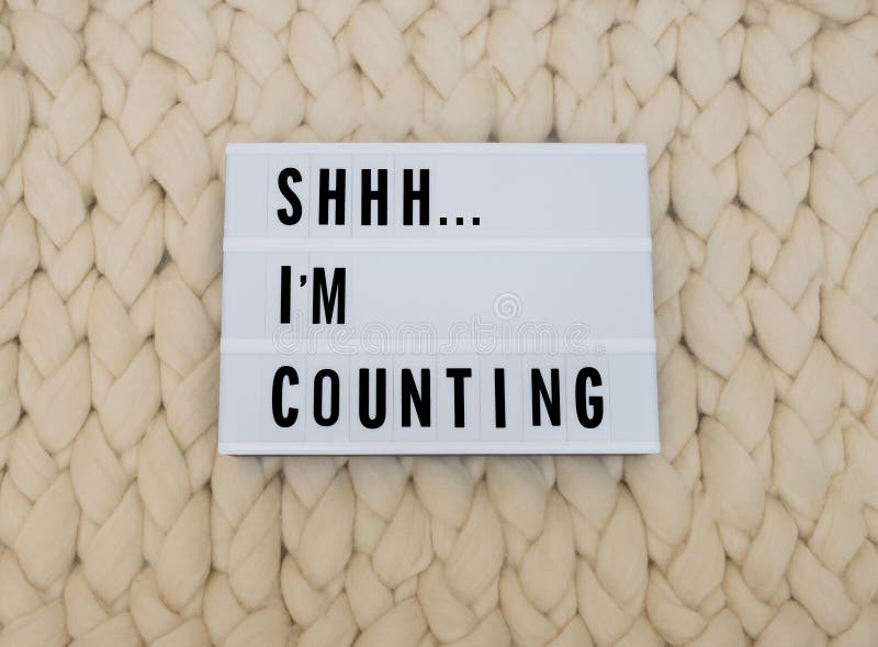 SHHH...I`M COUNTING word on lightbox on knit background. Cozy compozition. Knit WOOL background. SHHH...I`M COUNTING word on lightbox on knit background. Cozy compozition. Knit WOOL background