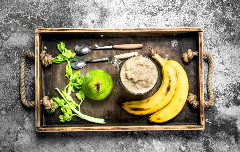 Smoothie with banana, pear and celery. On rustic background. Smoothie with banana, pear and celery. On rustic background