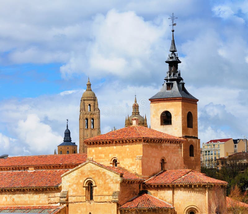 The San Milan church and in the background the Cathedral of Segovia in the medival city just north of Madrid in Spain. The San Milan church and in the background the Cathedral of Segovia in the medival city just north of Madrid in Spain