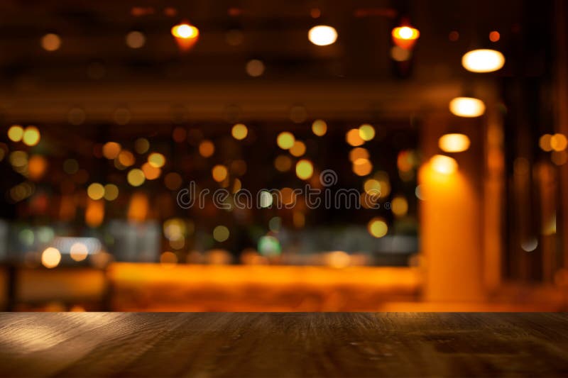 Top of wood table with bokeh of glor blur lamp light in party bar or pub in the Christmas dark night background. Top of wood table with bokeh of glor blur lamp light in party bar or pub in the Christmas dark night background