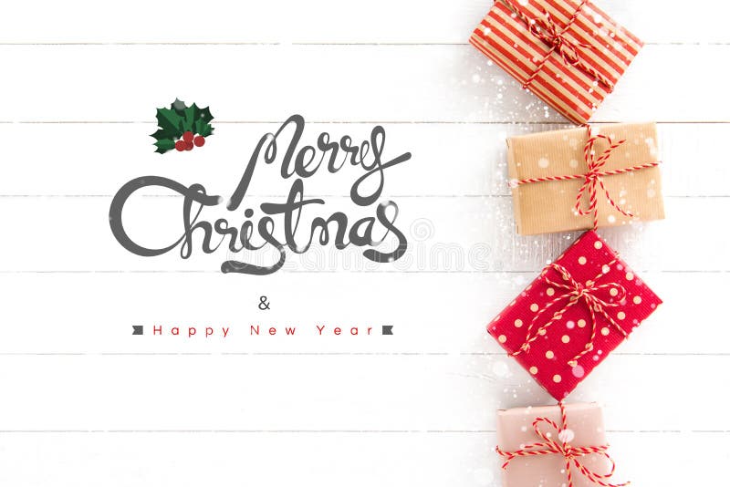 Merry Christmas and Happy New Year text with gift boxes on white wood background, top view. Merry Christmas and Happy New Year text with gift boxes on white wood background, top view