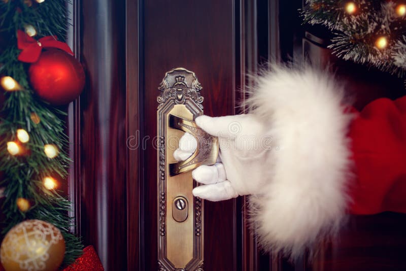 Santa Claus gloved hands open the door close up. Santa Claus gloved hands open the door close up