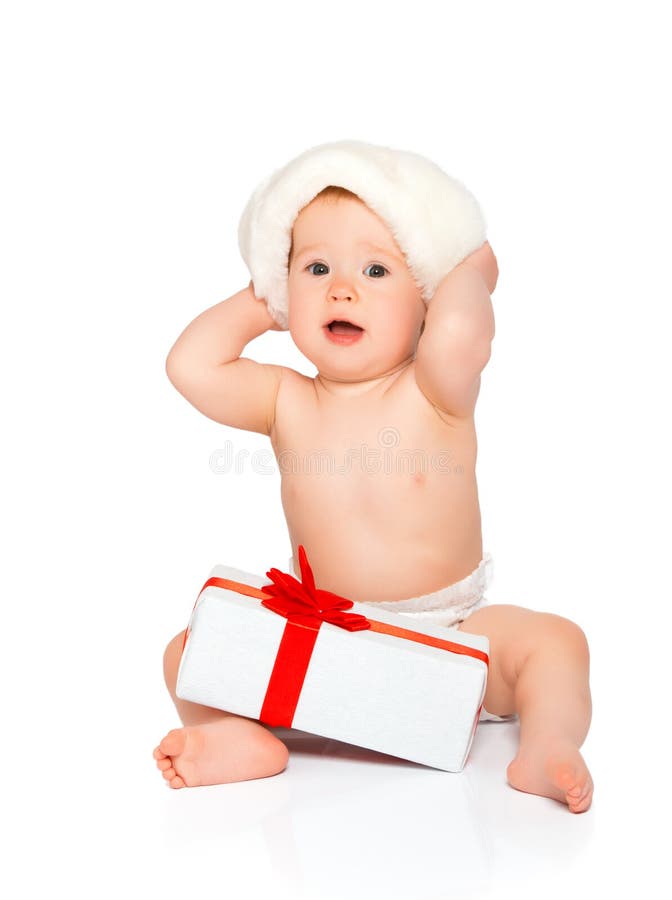 Happy baby in a Christmas hat with a gift isolated on white background. Happy baby in a Christmas hat with a gift isolated on white background