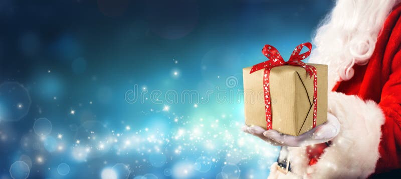 Christmas Gift - Santa Claus Giving Gift Box In Magic Night. Christmas Gift - Santa Claus Giving Gift Box In Magic Night