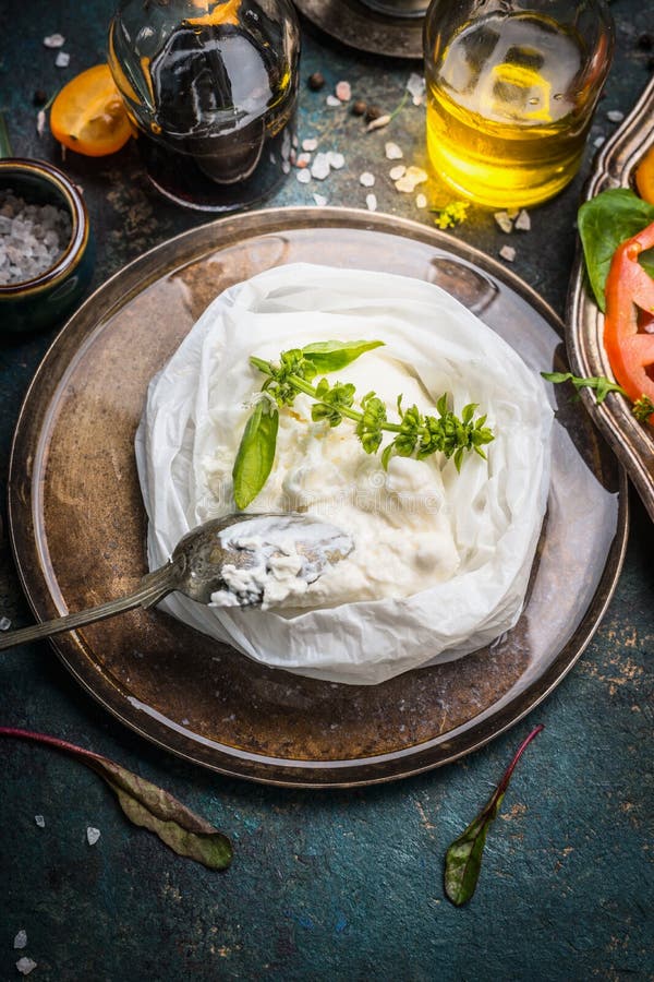 Handmade ricotta cheese on dark rustic kitchen table with italian food ingredients, close up. Handmade ricotta cheese on dark rustic kitchen table with italian food ingredients, close up