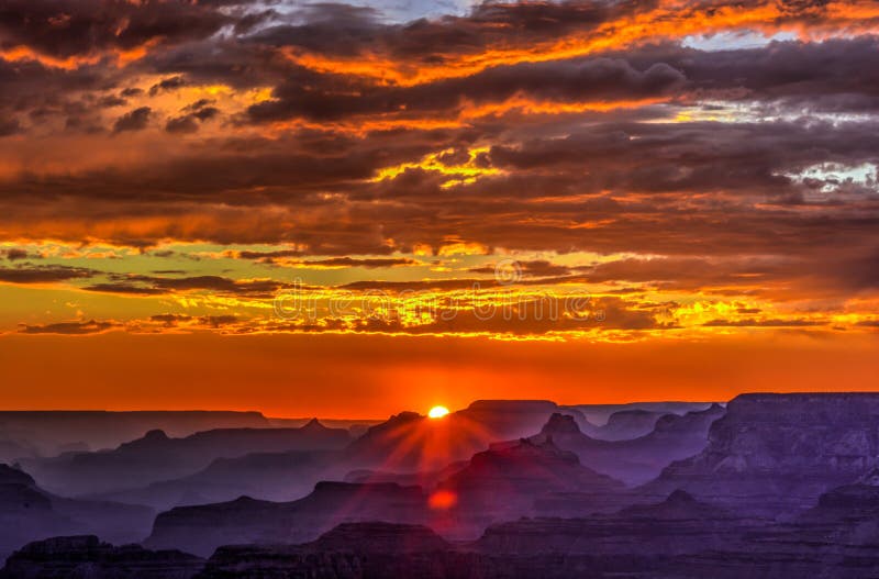 Golden Sunset at Lipan Point, Grand Canyon Arizona. Blue smoky haze accentuates the canyon. Golden Sunset at Lipan Point, Grand Canyon Arizona. Blue smoky haze accentuates the canyon.