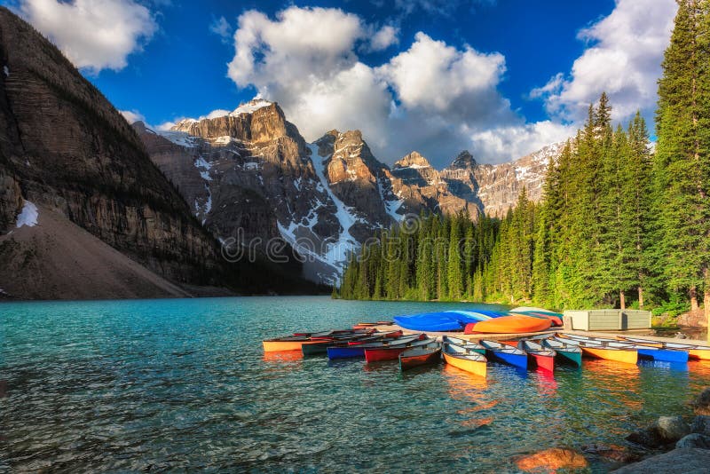 Beautiful turquoise waters of the Moraine Lake with snow-covered peaks above it in Rocky Mountains, Banff National Park, Canada. Beautiful turquoise waters of the Moraine Lake with snow-covered peaks above it in Rocky Mountains, Banff National Park, Canada.