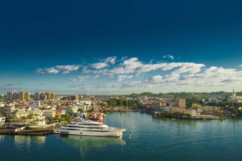 Huge motor boat in the port of Pointe-a-Pitre, with beautiful city on background Guadeloupe. Huge motor boat in the port of Pointe-a-Pitre, with beautiful city on background Guadeloupe.