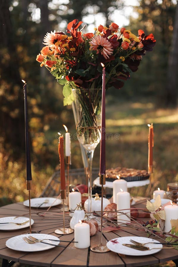 在公园里舒适的秋日野餐. 彩色白板餐具玻璃花瓶桌位特写