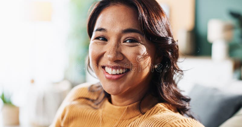 在公寓中，肖像放松、快乐的亚洲女人在休息室享受周末的宁静和宁静. 脸色微笑与女性 库存图片