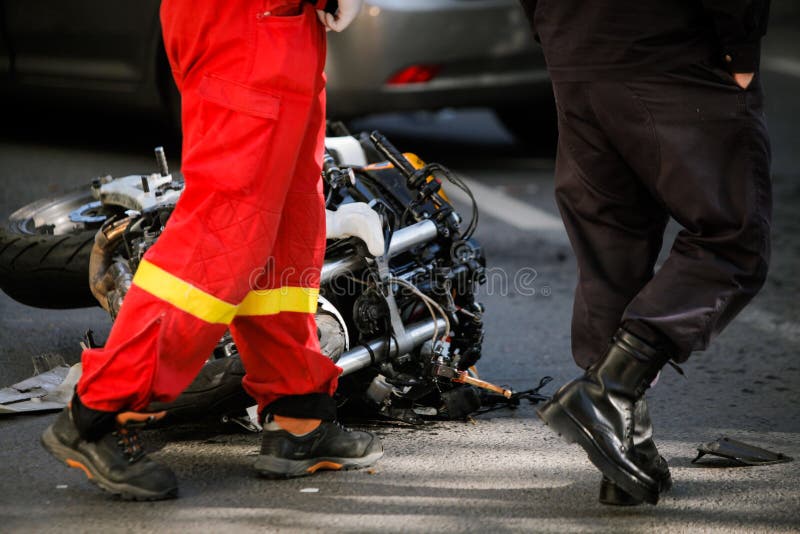 在公路事故以后的被碰撞的摩托车与汽车 免版税库存图片
