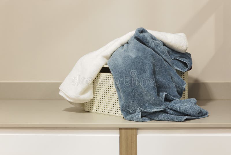 Dirty towels in a basket ready to be washed. Horizontal. Dirty towels in a basket ready to be washed. Horizontal