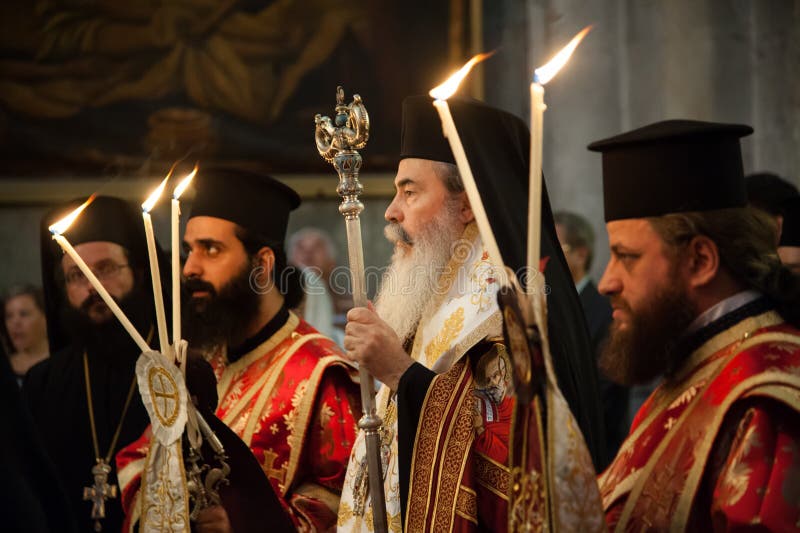 Greek Orthodox clergy hold candles during a mass in Jerusalem's Church of the Holy Sepulchre, traditional site of the crucifixion, burial, and resurrection of Jesus Christ. Greek Orthodox clergy hold candles during a mass in Jerusalem's Church of the Holy Sepulchre, traditional site of the crucifixion, burial, and resurrection of Jesus Christ.