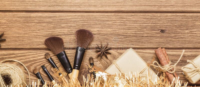 Makeup in christmas time web banner. Makeup Brush and Hand crafted Christmas gift box on wood background. Giving makeup as a present for Christmas, New year or other anniversary, top, view, accessories, artist, assortment, beautiful, beauty, brown, celebration, collection, composition, copy, space, cosmetic, cosmetics, decorative, face, facial, fashion, flat, lay, glamour, happy, holiday, holidays, lifestyle, merry, party, powder, product, products, seasonal, shopping, winter, women, wooden, www, xmas. Makeup in christmas time web banner. Makeup Brush and Hand crafted Christmas gift box on wood background. Giving makeup as a present for Christmas, New year or other anniversary, top, view, accessories, artist, assortment, beautiful, beauty, brown, celebration, collection, composition, copy, space, cosmetic, cosmetics, decorative, face, facial, fashion, flat, lay, glamour, happy, holiday, holidays, lifestyle, merry, party, powder, product, products, seasonal, shopping, winter, women, wooden, www, xmas