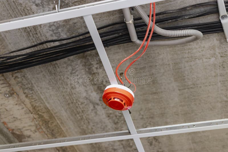 Installation of a fire detector on the ceiling. Security system in the building. Fire fighting devices for warning of danger. Installation of a fire detector on the ceiling. Security system in the building. Fire fighting devices for warning of danger.