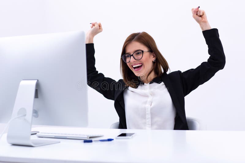 Excited businesswoman rejoicing at her success cheering and raising her fists in the air. Excited businesswoman rejoicing at her success cheering and raising her fists in the air