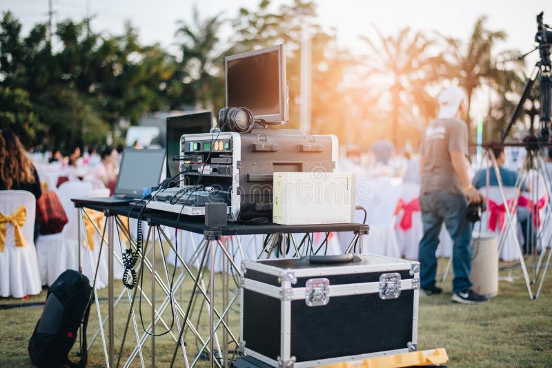 Dj mixing equalizer at outdoor in music party festival with party dinner table. Entertainment and Event organizer concept. Concert and Musical theme, monitoring, sunset, sound, studio, audio, radio, mixer, equipment, stage, system, turntable, professional, media, disco, background, summer, electronic, vinyl, people, live, light, fun, lifestyle, technology, dance, play, button, board, desk, control, modern, street, video, market, camera, man, person. Dj mixing equalizer at outdoor in music party festival with party dinner table. Entertainment and Event organizer concept. Concert and Musical theme, monitoring, sunset, sound, studio, audio, radio, mixer, equipment, stage, system, turntable, professional, media, disco, background, summer, electronic, vinyl, people, live, light, fun, lifestyle, technology, dance, play, button, board, desk, control, modern, street, video, market, camera, man, person