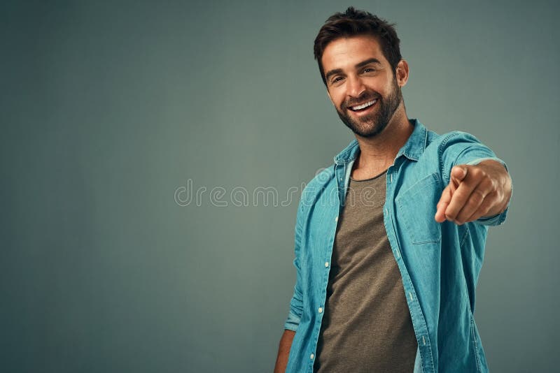 Pointing, mockup or portrait of happy man in studio for choosing accountability, motivation or decision. Space, smile or male model with hey you hand gesture isolated on background for option offer. Pointing, mockup or portrait of happy man in studio for choosing accountability, motivation or decision. Space, smile or male model with hey you hand gesture isolated on background for option offer.