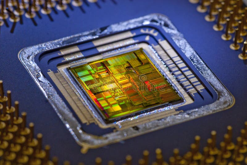 An uncapped Microprocessor with a closeup of the silicone chip and circuitry. An uncapped Microprocessor with a closeup of the silicone chip and circuitry