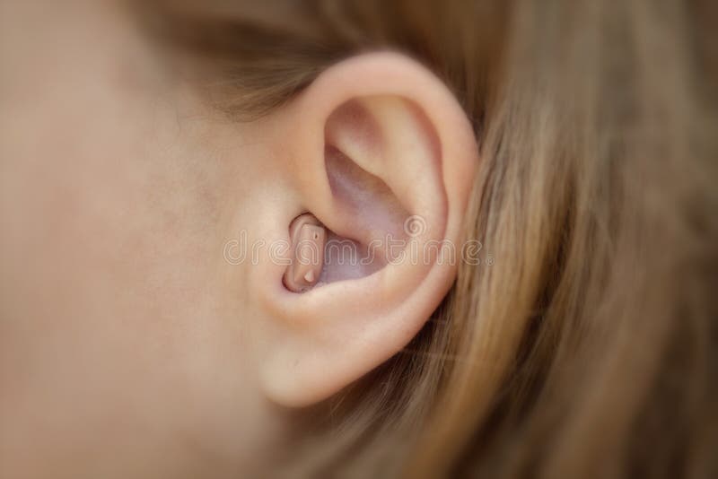 Hearing aid in your ear close-up. Modern equipment in medicine. Hearing aid in your ear close-up. Modern equipment in medicine