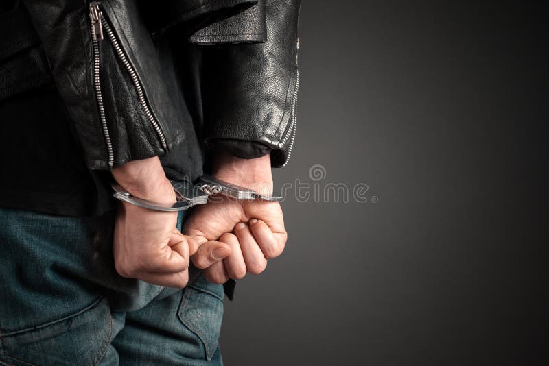 Man hands in handcuffs on hand. Man hands in handcuffs on hand