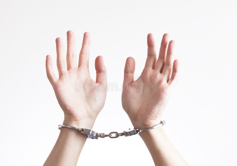 Arrested criminal hands in handcuffs isolated in white. Arrested criminal hands in handcuffs isolated in white