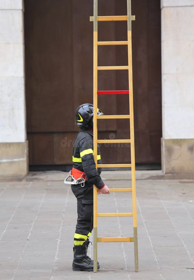 Many firemen during rescue operations with a big wooden ladder. Many firemen during rescue operations with a big wooden ladder