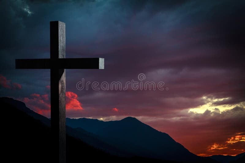 Jesus Christ cross on a background with dramatic sky and colorful, red, orange, purple sunset on blue mountains. Easter, resurrection concept. Jesus Christ cross on a background with dramatic sky and colorful, red, orange, purple sunset on blue mountains. Easter, resurrection concept