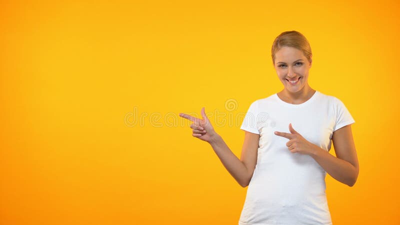 在橙色背景，模板介绍的有吸引力的女性指向的手指