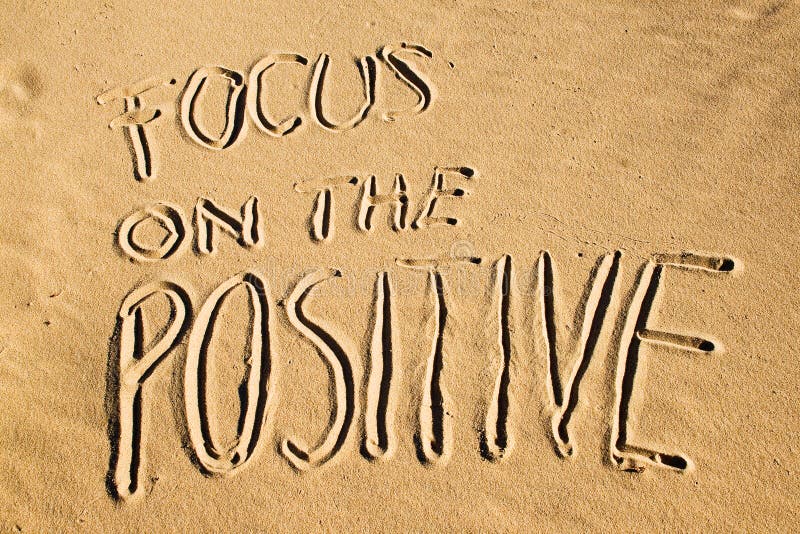 Focus on the positive. Creative motivation concept written in the sand at the beach. Focus on the positive. Creative motivation concept written in the sand at the beach.