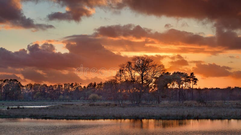 Beautiful red and orange colored sunset at a wetland, Turnhout, Belgium. Beautiful red and orange colored sunset at a wetland, Turnhout, Belgium