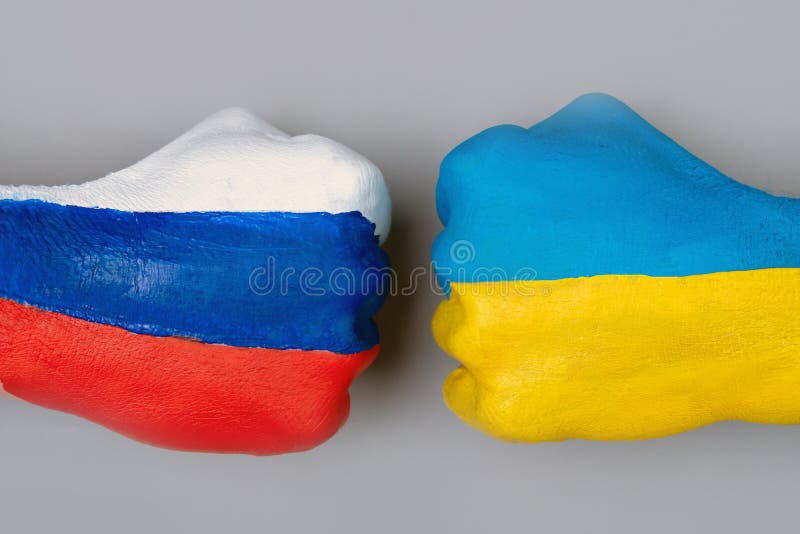 Flags of Ukraine and Russia Flag on hands punch to each others on light gray world map background, Ukraine vs Russia in world war crisis concept. Flags of Ukraine and Russia Flag on hands punch to each others on light gray world map background, Ukraine vs Russia in world war crisis concept.