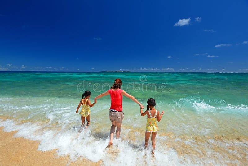 Young Family Relaxing On Beach Holiday. Young Family Relaxing On Beach Holiday