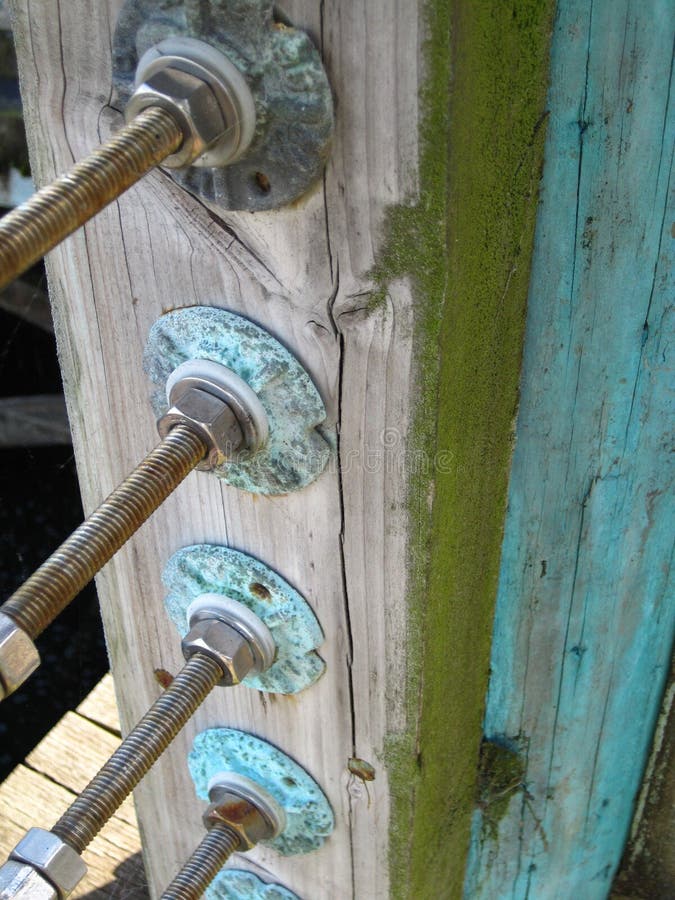 A worn and weathered post with moss on a harbor peer. A worn and weathered post with moss on a harbor peer.