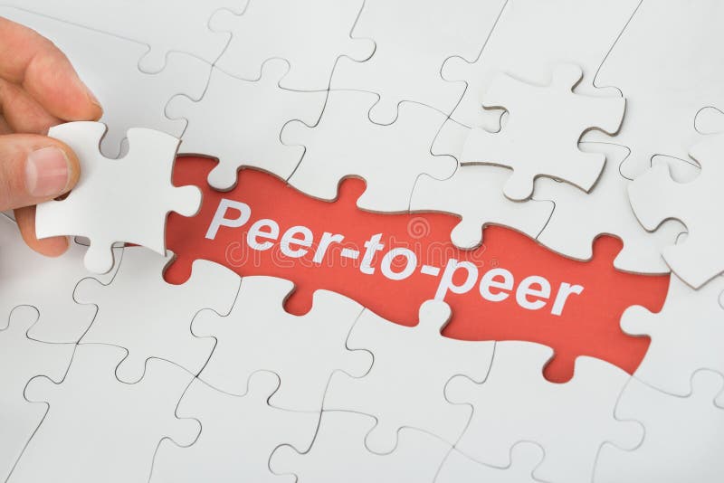 Person Holding Jigsaw Puzzle Piece With Peer-to-peer Text. Person Holding Jigsaw Puzzle Piece With Peer-to-peer Text