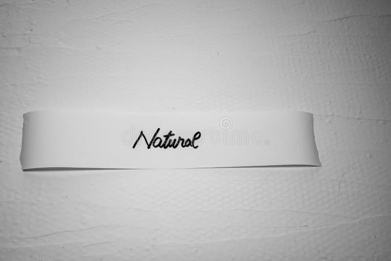 Writing natural on white label on white background. Writing natural on white label on white background..