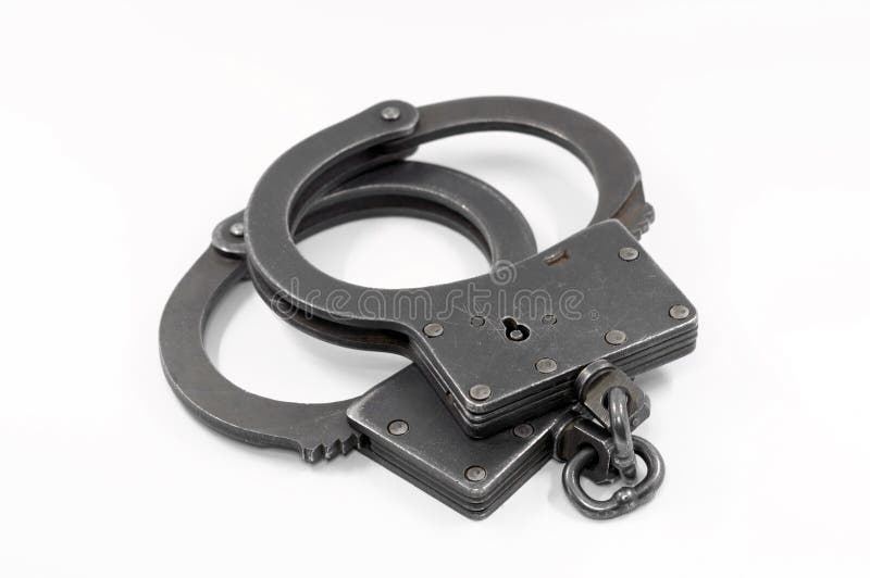 Police handcuffs on a white background. Police handcuffs on a white background.