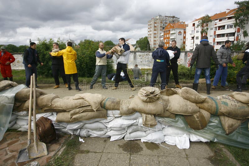 SERBIA, SREMSKA MITROVICA - MAY 17: The army, police and citizens together raise the walls banks with sandbags.The water level of Sava River remains high in worst flooding on record across the Balkans on may 17, 2014. SERBIA, SREMSKA MITROVICA - MAY 17: The army, police and citizens together raise the walls banks with sandbags.The water level of Sava River remains high in worst flooding on record across the Balkans on may 17, 2014