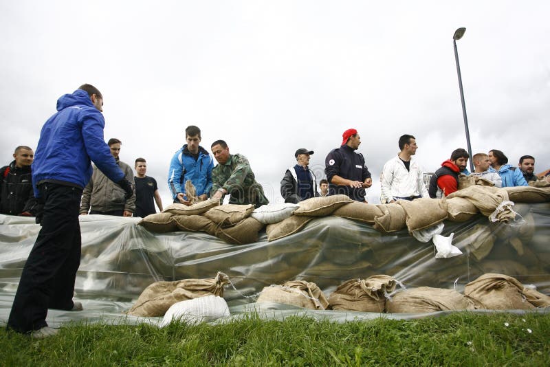 SERBIA, SREMSKA MITROVICA - MAY 17: The army, police and citizens together raise the walls banks with sandbags.The water level of Sava River remains high in worst flooding on record across the Balkans on may 17, 2014. SERBIA, SREMSKA MITROVICA - MAY 17: The army, police and citizens together raise the walls banks with sandbags.The water level of Sava River remains high in worst flooding on record across the Balkans on may 17, 2014