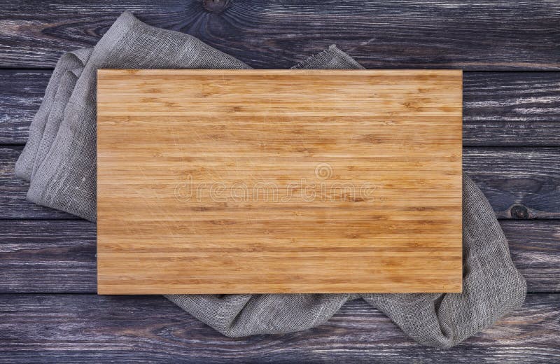 Serving tray on old wooden table, cutting board on dark wood background, top view. Serving tray on old wooden table, cutting board on dark wood background, top view