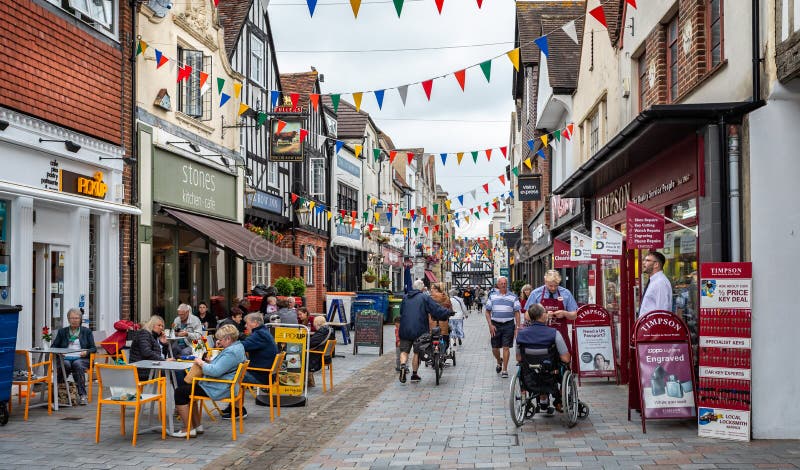 Outdoor coffee drinkers in Butchers Row festooned with bunting in Salisbury, Wiltshire, UK on 29 June 2021. Outdoor coffee drinkers in Butchers Row festooned with bunting in Salisbury, Wiltshire, UK on 29 June 2021