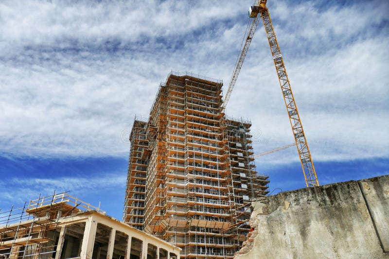 new residential building under construction on a dismissed industrial area view from below. new residential building under construction on a dismissed industrial area view from below