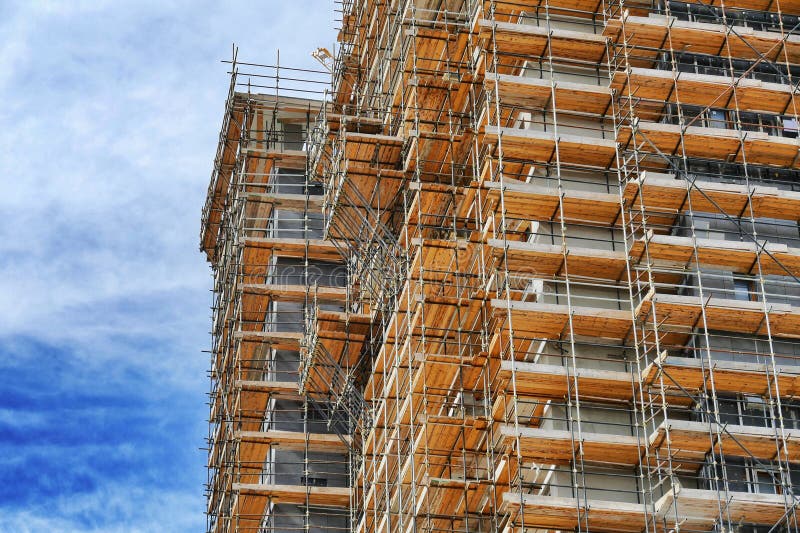 new residential building under construction on a dismissed industrial area view from below. new residential building under construction on a dismissed industrial area view from below